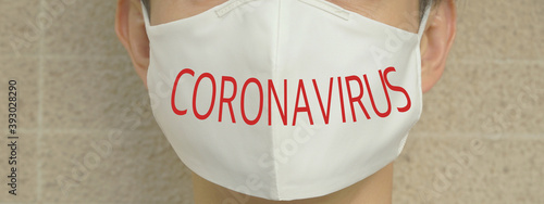 Young man wearing white cotton face mask during Coronavirus (Covid-19) pandemic.