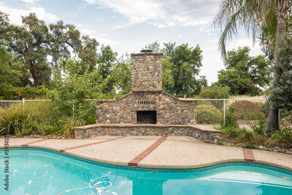 Northern California suburban villa backyard with pool and fireplace