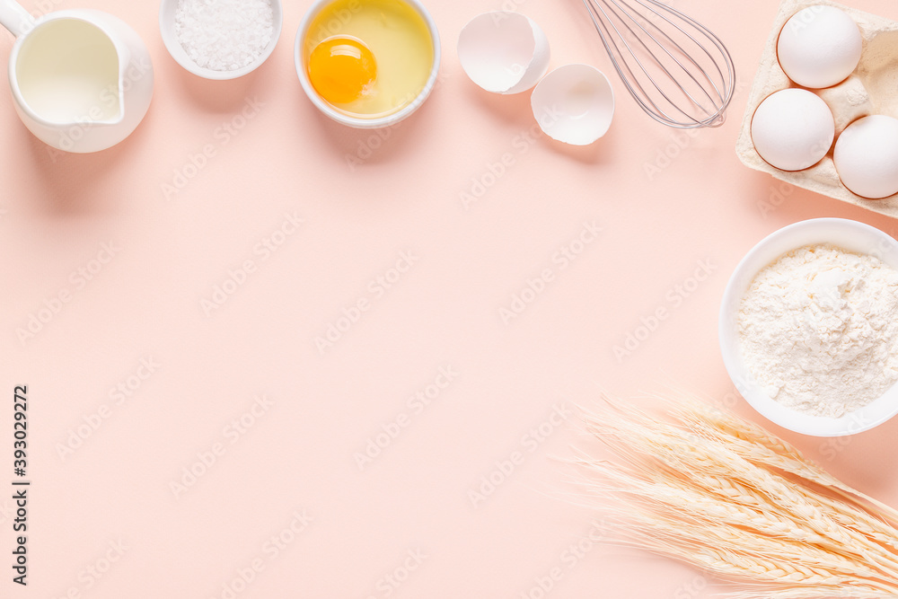 Fototapeta premium Ingredients for baking on light pink background.