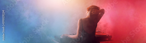 Female dj playing music in ...