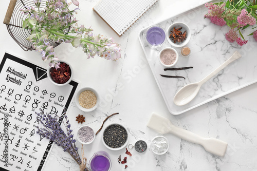 Alchemical symbols and ingredients for preparing potions on white background