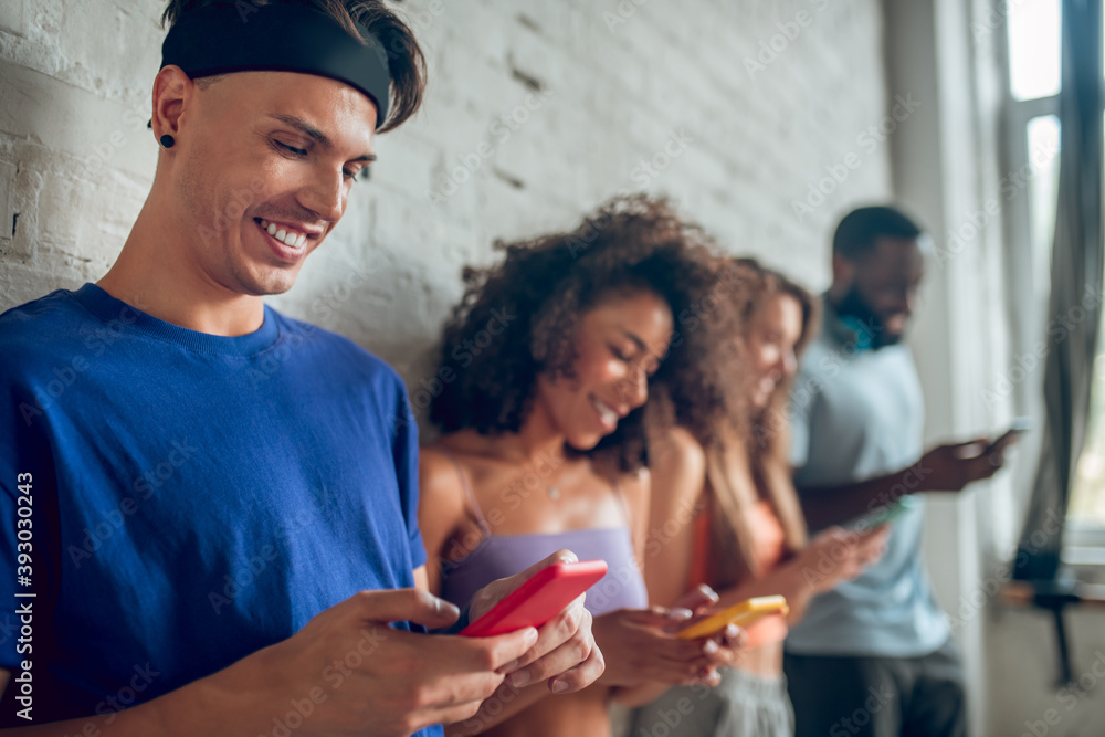 Fototapeta premium Group of young people using their smartphones