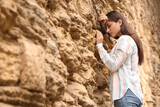 Young woman praying near the Wailing Wall