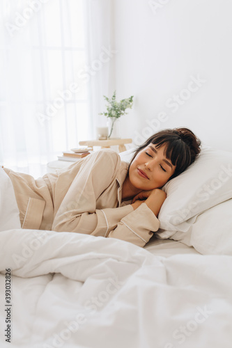 Woman sleeping on bed photo