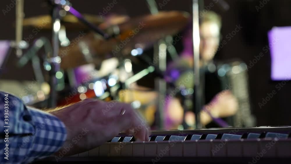 Big hands on the keys of the synthesizer. Big hands on the keys of the synthesizer.