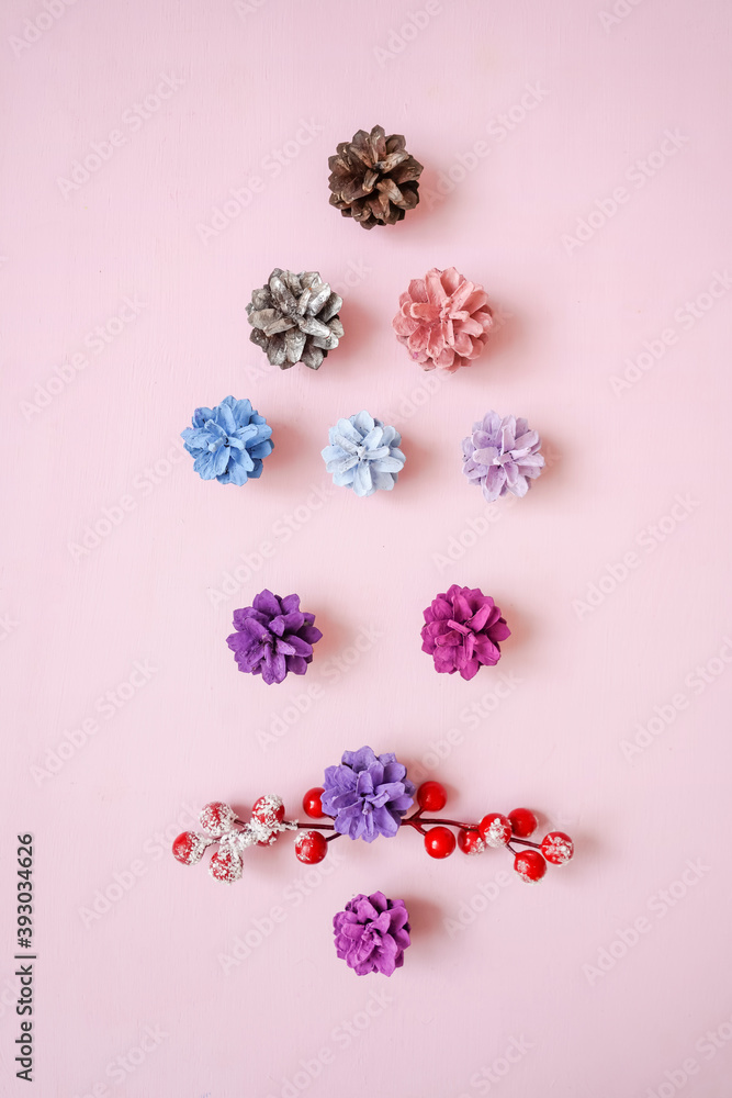 Face santa claus from multi-colored pine cones and berries on pink background. Flat lay, top view. Face santa claus from multi-colored pine cones and berries on pink background. Flat lay, top view.