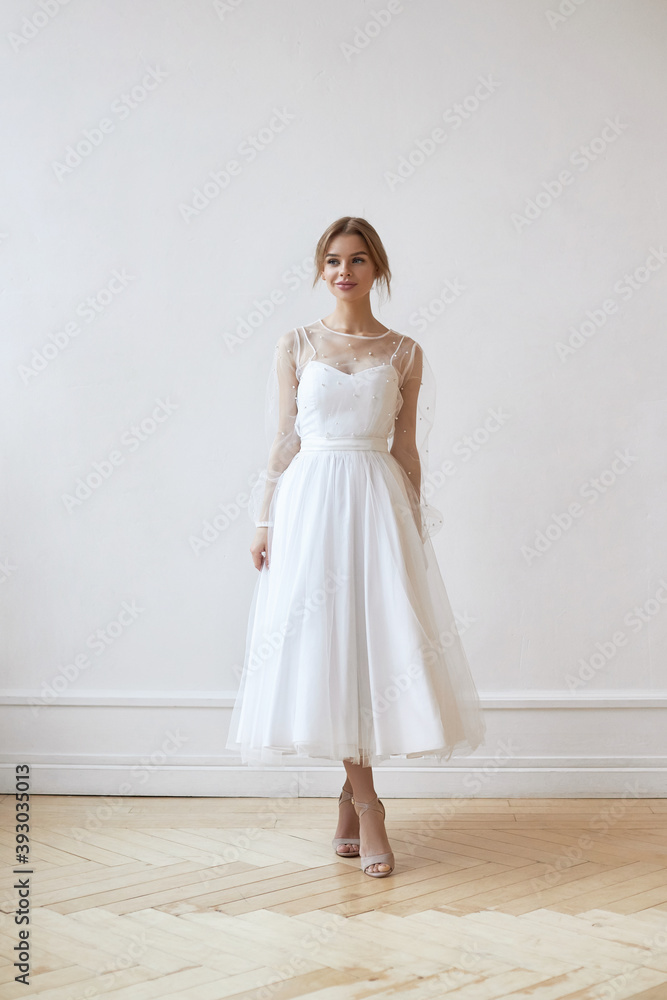 Beautiful slender woman in white wedding dress, new collection of dresses for the bride. Noise, out of focus Beautiful slender woman in white wedding dress, new collection of dresses for the bride. Noise, out of focus