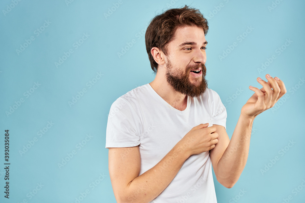 Cheerful man gesturing with his hands emotions cropped view on blue background studio Cheerful man gesturing with his hands emotions cropped view on blue background studio