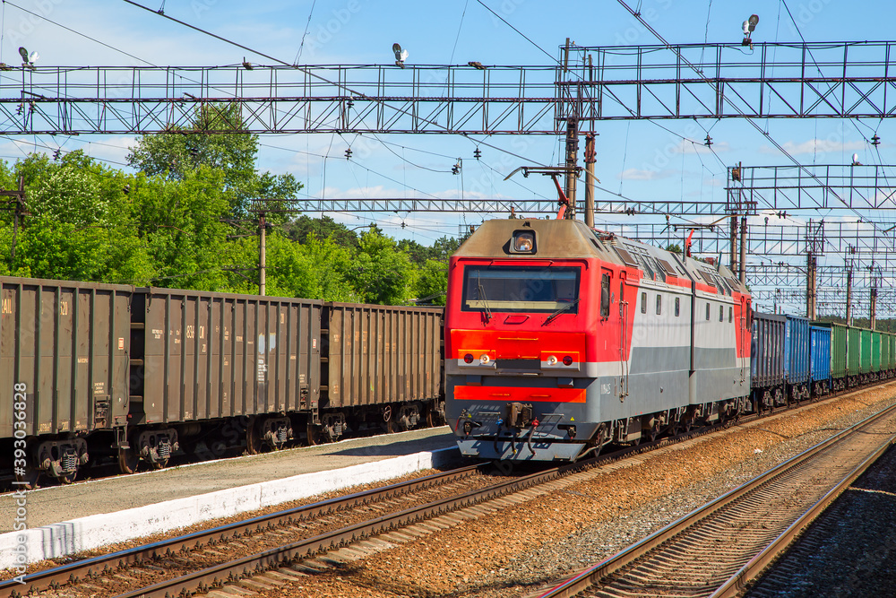 Freight, train at the station. Horizontally.