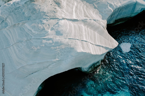 Aerial drone photographs of Sarakiniko Beach moonscapes in Milos Island, Greece surrounded by crystal clear turquoise waters and waves of the Aegan Sea photo