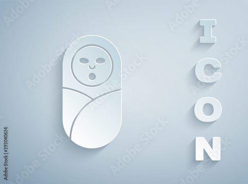 Paper cut Newborn baby infant swaddled or swaddling icon isolated on grey background. Baby kid child wrapped in blanket clothes. Paper art style. Vector.