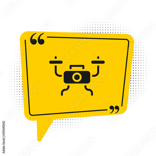 Black Drone flying icon isolated on white background. Quadrocopter with video and photo camera symbol. Yellow speech bubble symbol. Vector.