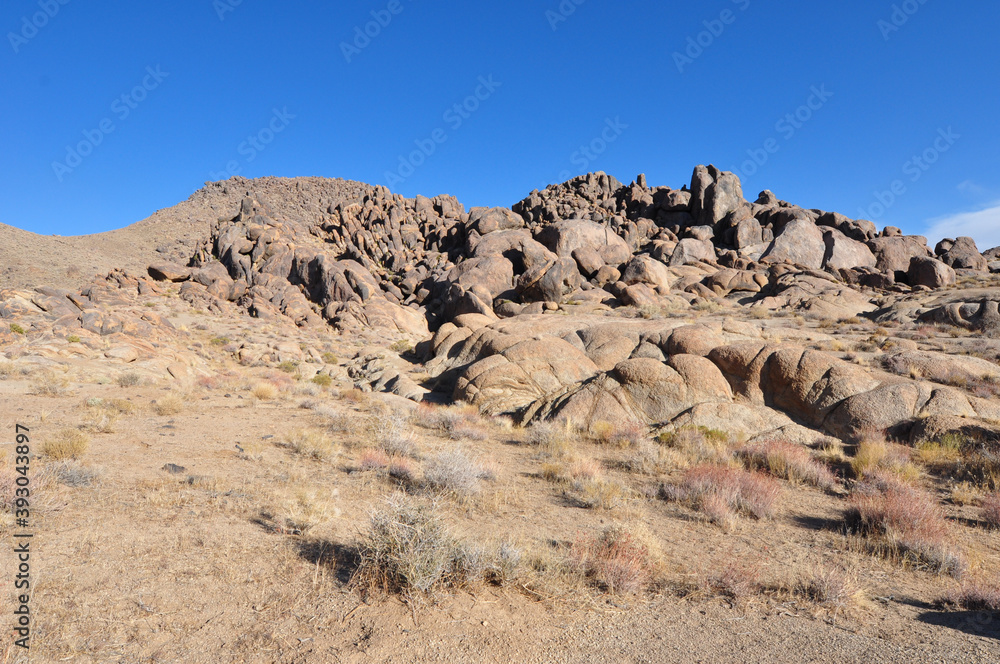The rocky landscape of the Alabama Hills in California on a bright sunny day
