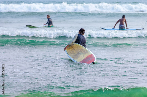 Surfer enters the water