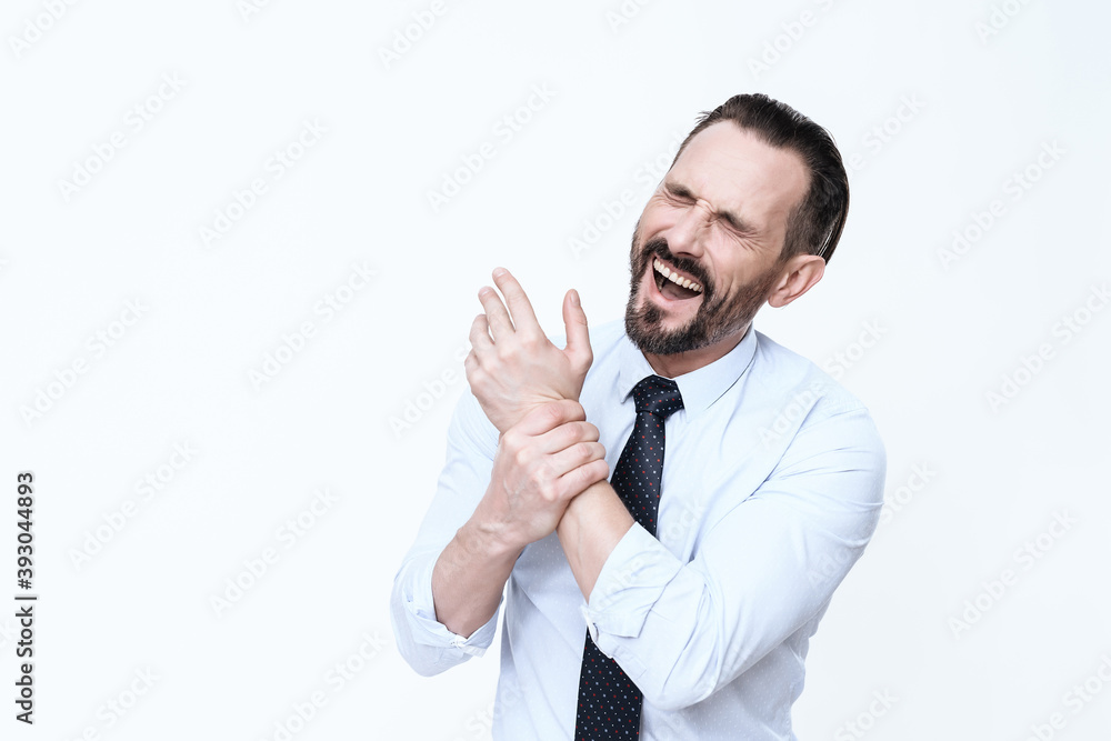 A man screams from severe pain in his hand. A man screams from severe pain in his hand.