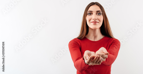 Portrait of Pretty girl reaching palms of hand to the camera giving assistance and acceptance. Copy space