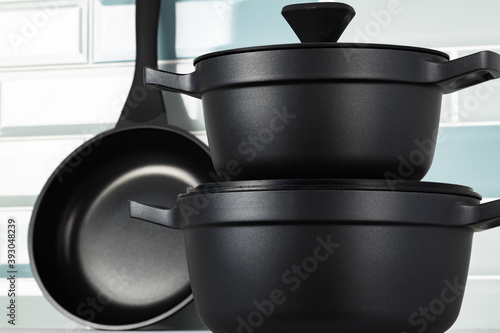 Set of black cookware on kitchen counter photo