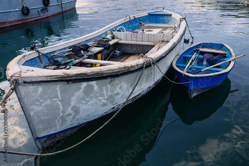 Kavarna, Bulgaria - September 2016: Large and small blue fishing boats lie next to each other in the harbor in the evening sun © Volker Vornehm