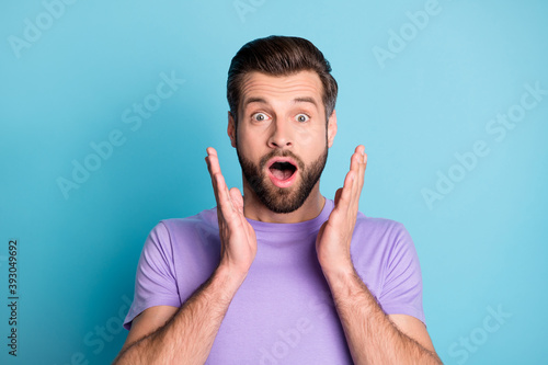Photo of young handsome man amazed shocked surprised news sale rumor isolated over blue color background