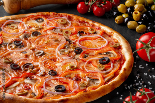 pizza on black background with ingredients