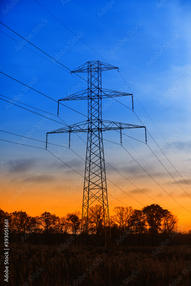 Fototapeta premium Transmission pole against the backdrop of a beautiful sunset