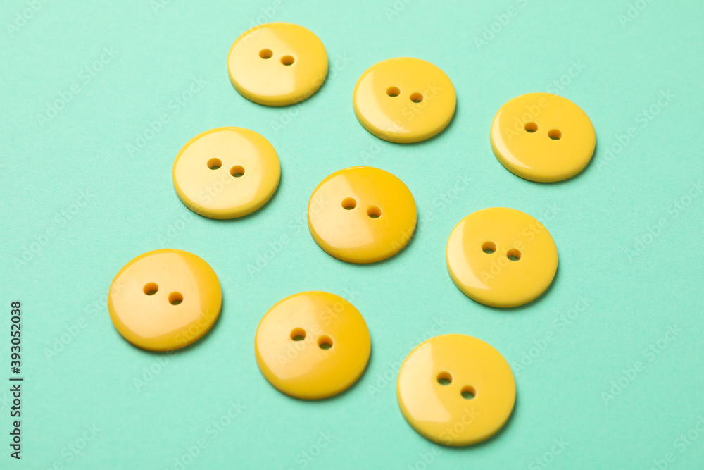 Flat lay with yellow buttons on mint background Flat lay with yellow buttons on mint background
