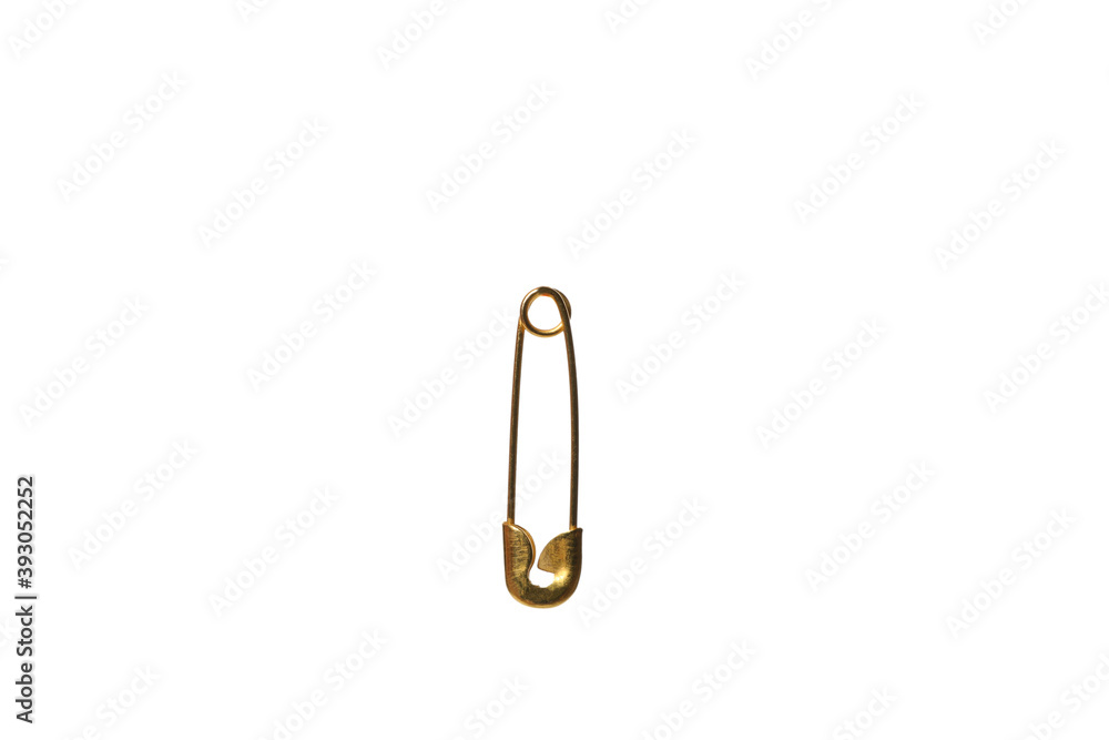 One golden safety pin isolated on white background One golden safety pin isolated on white background