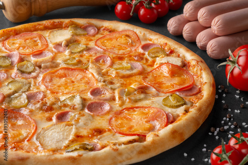 pizza on black background with ingredients