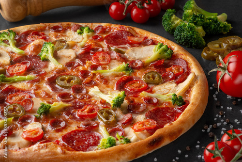 pizza on black background with ingredients