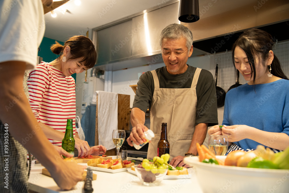 Men and Women Cooking in the Shared Kitchen Men and Women Cooking in the Shared Kitchen