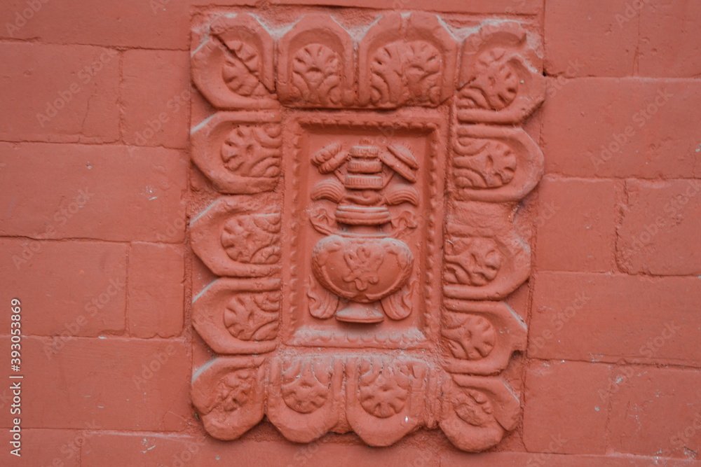 A design in a wall outside of a hindu temple in Kathmandu, Nepal.