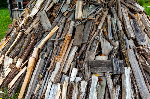 Firewood stacked in a pile close-up in summer