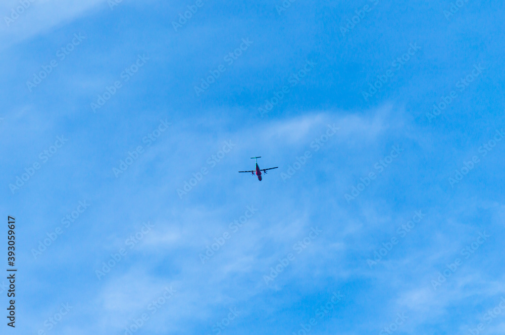 An airplane flying in the blue sky An airplane flying in the blue sky