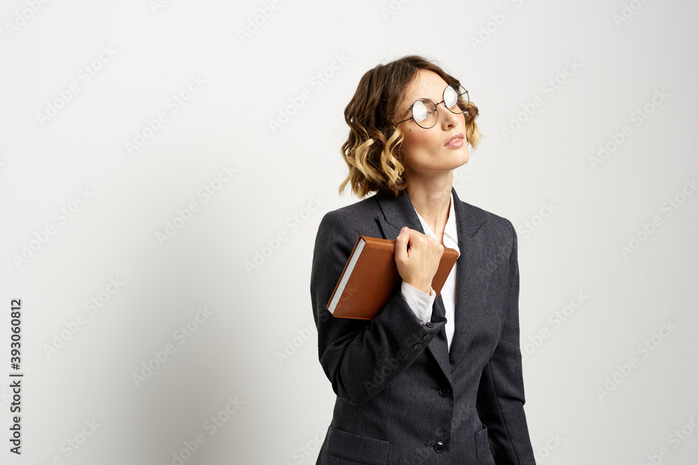 business woman in a suit with documents in hands light background curly hair hairstyle business woman in a suit with documents in hands light background curly hair hairstyle