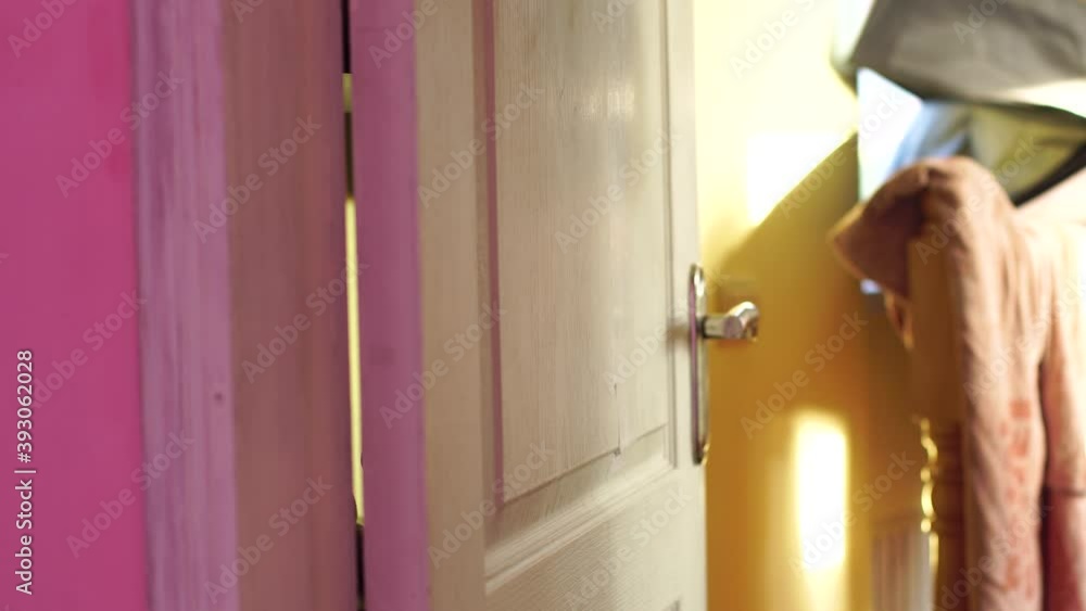 man paints the door in the room with a paint brush man paints the door in the room with a paint brush
