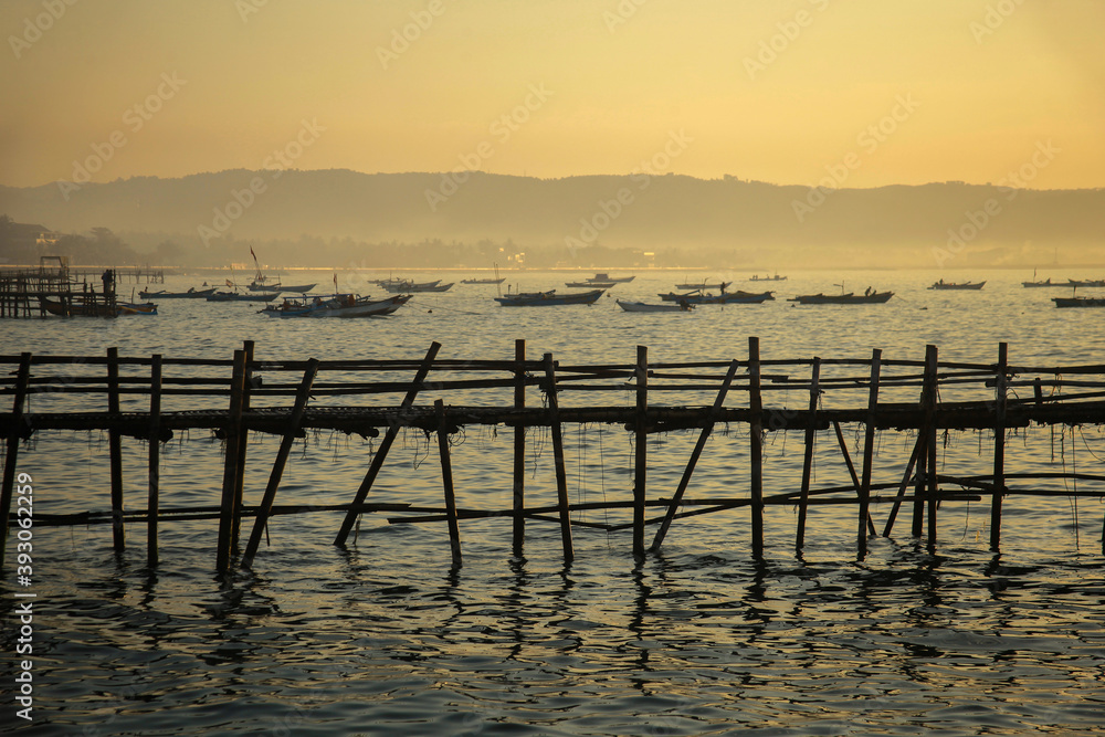 Sunrise view from sea with beautiful twilight sky, fishing boats preparing the trap with mountain in background. Sunrise view from sea with beautiful twilight sky, fishing boats preparing the trap with mountain in background.