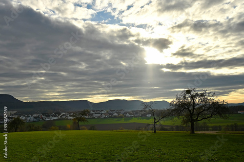 panoramic view to the Swabian highlands in Germany with dark sky and sun ray