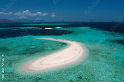 Aerial view of beautiful white sand island in shallow ocean with blue sky at Labuan Bajo Indonesia 