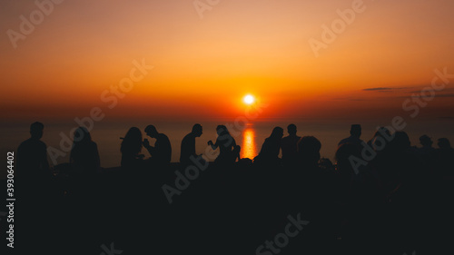 Silhouettes in amazing dramatic sunset on Lefkada  Greece seaside. Silhouette love during sunset. Vacation in Greece. Sparkling emotions.