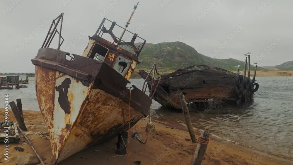 Ship cemetery on the shore of the Barents sea in the far Northern village of Teriberka on the Kola Peninsula, Russia. Smooth camera movement.