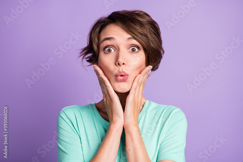 Close up portrait of impressed pretty girl hands on face lips staring turquoise outfit isolated on violet color background
