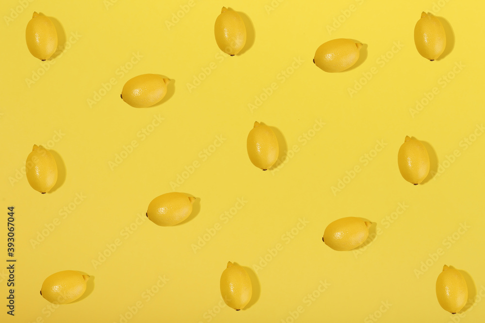 lemons on yellow background flat lay