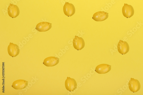 lemons on yellow background flat lay