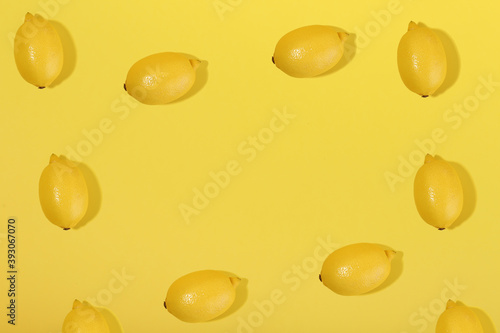 lemons on yellow background flat lay