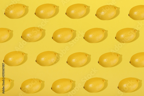 lemons on yellow background flat lay