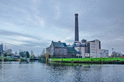 Leiden, The Netherlands, November 14, 2020: view across the city's ramparts canal towards the power plant at Langegracht