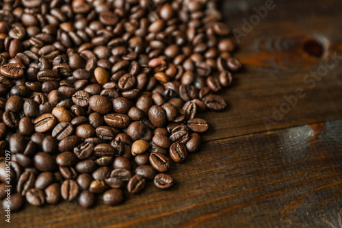 roasted coffee beans on dark wooden background