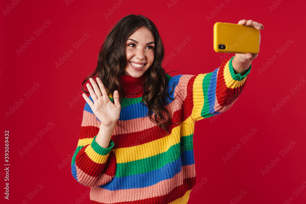 Happy beautiful girl taking selfie on cellphone and waving hand Happy beautiful girl taking selfie on cellphone and waving hand