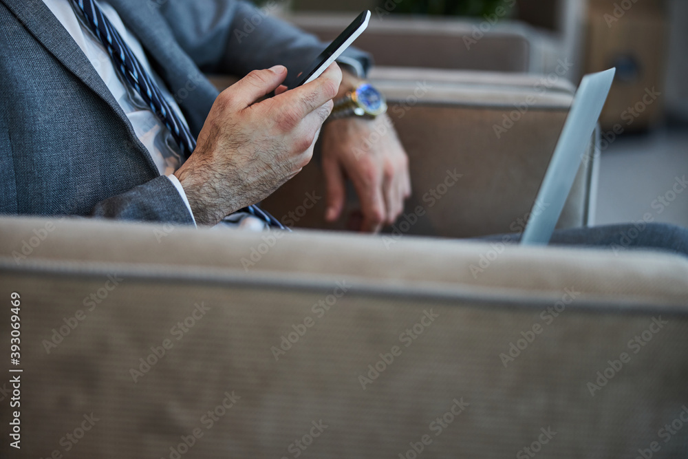 Man clicking on a phone in his hand