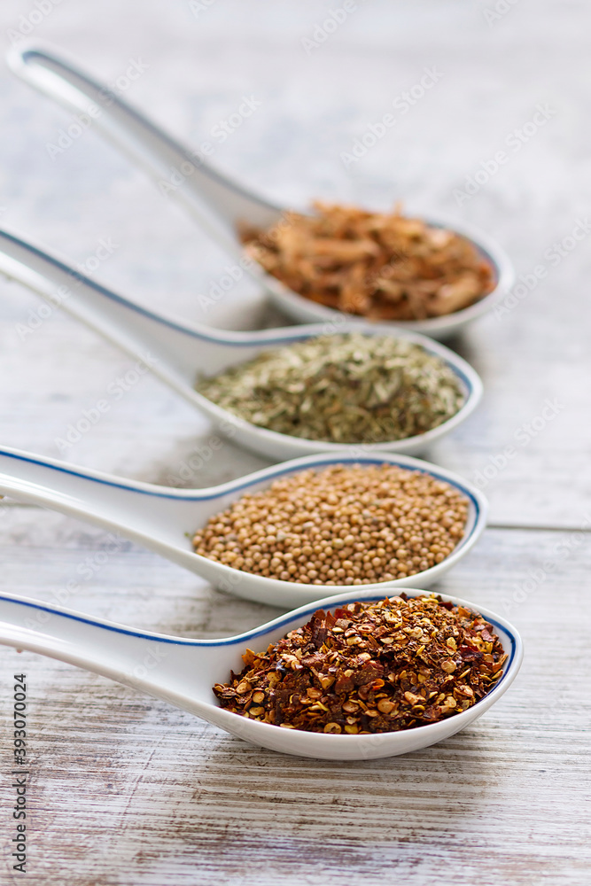 Fine spices and herbs in chinese porcelain spoons
